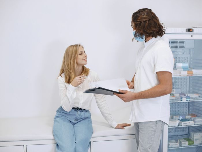 A woman discusses her test results with a clinician